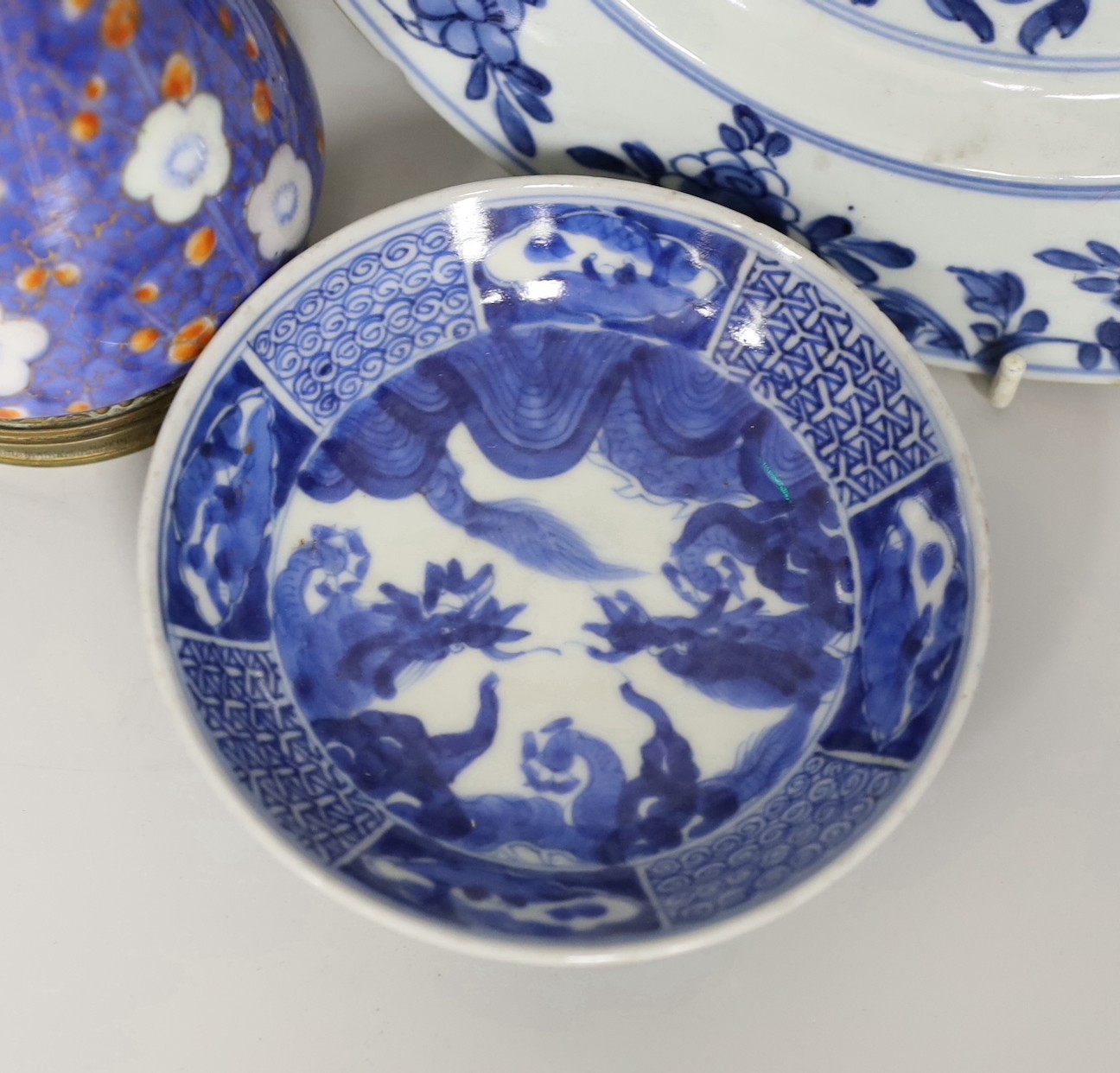 Three Chinese blue and white dishes and a bowl, together with an Imari vase. Largest 23cm diameter